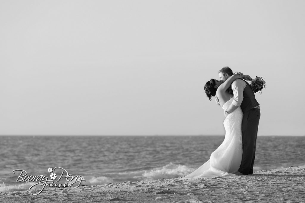 Bride and groom kissing on florida beach